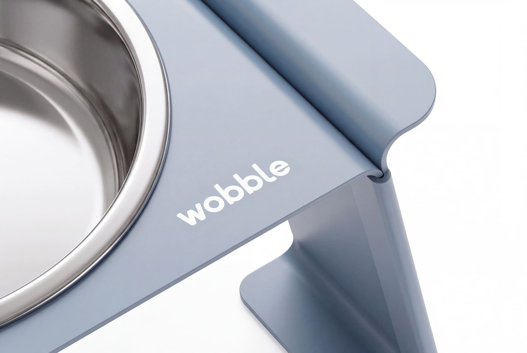 Wobble feeder close-up showing the handle detail and logo